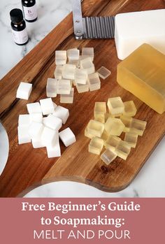 a wooden cutting board topped with cubes of soap next to a knife and block of butter