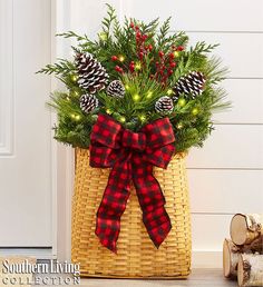 a basket filled with pine cones and greenery