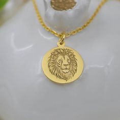 Embrace the Majesty of the Lion with Our 14K Solid Gold Lion Head Necklace Our 14K Solid Gold Lion Head Necklace captures the essence of the majestic lion, a timeless symbol of strength, courage, and royal authority. Crafted with exquisite detail, this stunning piece is perfect for anyone who admires the king of the jungle. Features: Material: High-quality 14K solid gold Design: Intricately detailed lion head pendant Style: Animal, Majestic, Symbolic Pendant Size: (specify size) Chain Length: (s Safari Jewelry, Lion Head Necklace, Majestic Lion, Symbol Of Strength, Jewelry King, Lion Pendant, King Of The Jungle, Face Pendant, Head Necklace