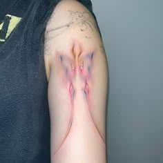 a man with a tattoo on his arm has pink and white designs on it's arms