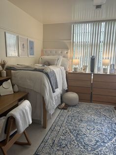 a bed room with a neatly made bed and a rug