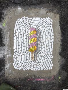 an ice cream sundae is painted on the ground with white and pink squares around it