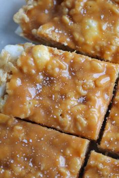 pieces of caramel rice krispy treats on top of each other with marshmallows