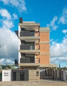 an apartment building with balconies on the second floor