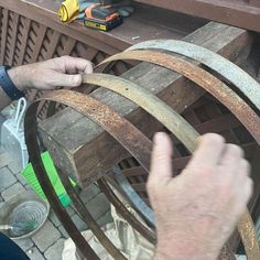 a man is working on an old wooden barrel