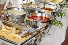 a buffet table filled with lots of different types of food and condiments on it