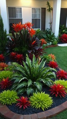 a flower garden in front of a house