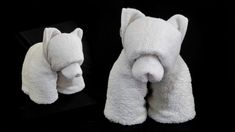 two white towels folded in the shape of animals, one with its mouth open and another with it's eyes closed