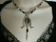 "This beautiful necklace has purple Czech glass beads, pewter silver filigree beads, seed beads, pearl beads, clear Czech glass beads, pewter silver crescent moons, pewter silver goddess and a sterling silver plated filigree pendant with a purple catseye stone with rhinestones. 18\" long. Toggle clasp." Mystical Purple Necklace For Festivals, Bohemian Silver Amethyst Beaded Necklace, Mystical Silver Gemstone Bead Necklace, Mystical Silver Necklace With Gemstone Beads, Mystical Silver Necklace With Round Beads, Spiritual Silver Amethyst Beaded Necklace, Sixteen Wishes, Jewelry Witchcraft, Gothic Jewelry Diy