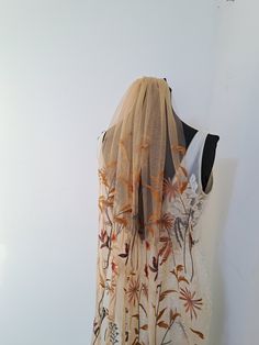 a white dress with orange flowers on it