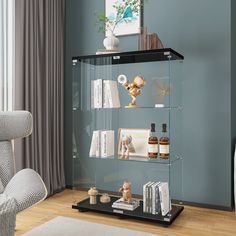 a glass shelf with bottles and books on it in a room next to a chair