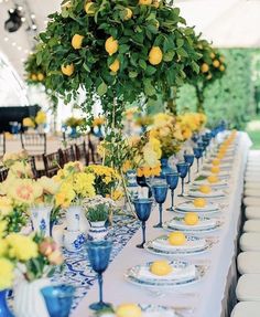 an image of a table setting with lemons and blue glassware on the table