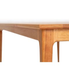 a close up of a wooden table on a white background with no one around it