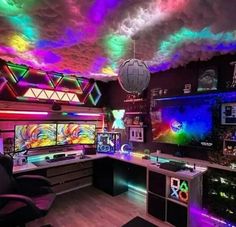 a room filled with lots of different colored lights and computers on top of desks