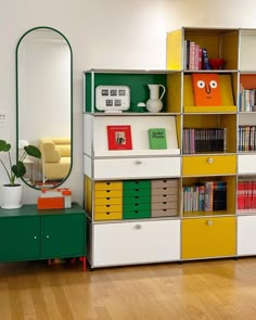 a book shelf with many books on it and a mirror in the corner next to it