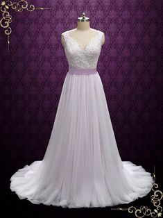 a dress on display in front of a purple wall