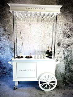 an ice cream cart with champagne bottles on top