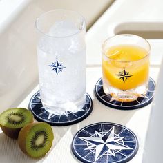 two coasters with kiwi slices and a drink on them