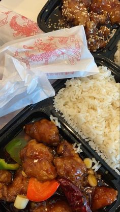 two plastic trays filled with rice and meat next to some vegtables