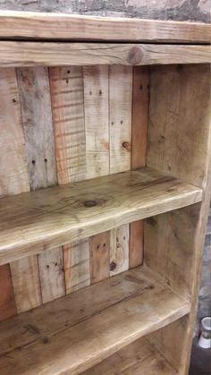 an old wooden bookcase with two shelves made out of pallet boards and wood planks