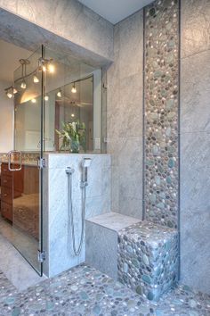 a bathroom with a walk in shower next to a sink