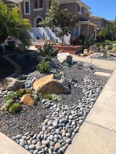 a rock garden in front of a house