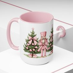 a pink and white coffee mug with an image of a nutcracker on it