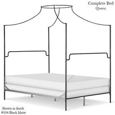 an iron bed frame with four posts and white sheets on the bottom, shown in black matte