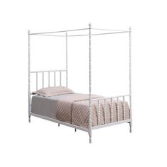 a white metal bed frame with four posts