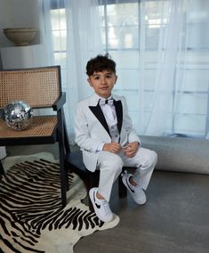 5 Piece Fashion Sequin Tuxedo Set dapper your little gentleman right up! This look is smoother than sequins with its glitter finish.  Talk about wanting to be the star of the occasion, or even just a little bling bling. Boy's 5-Piece Fashion Sequin Tuxedo Set consists of a high quality jacket, a double breasted vest, pants, shirt and bowtie.  Peak Lapel Jacket offers side vents for ventilation and comfort. Comes with matching pants. Pants need to be hemmed/tailored to match his height.  Modern Sequin Tuxedo Set is European Cut which makes it really slim, so please keep allowances in mind. Whatever the occasion, may it be a part, a wedding, or even just another day out and about- we are here for the moments for that matter! Fitted White Three-piece Suit For Party, White Fitted Three-piece Suit For Party, White Fitted Three-piece Party Suit, White Tuxedo Three-piece Suit For Party, White Three-piece Suit For Party, White Tuxedo Set For Party, White Tuxedo Style Party Set, White Tuxedo Party Set, Classic White Sets For Black Tie Occasions