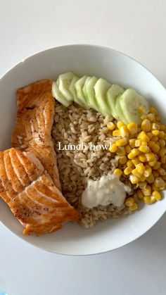 a white bowl filled with fish, rice and vegetables