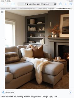 a living room filled with furniture and a fire place in front of a book shelf