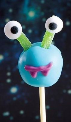 an odd looking cake on a stick with googly eyes