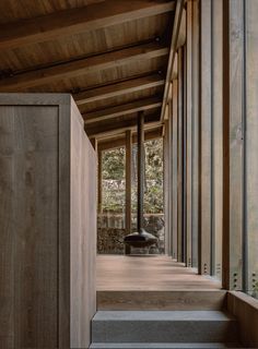 the inside of a building with wooden walls and stairs leading up to an open area