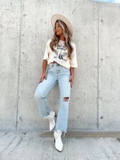 Feel confident in Lane 201's Light Wash Boyfriend Denim. The jeans feature the perfect boyfriend fit, some light distressing, a hole detail in one knee, and a distressed hem. These jeans fit big in the waistline. High Rise Boyfriend Fit Ankle Length Light Distressing Throughout Distressed Hem 100% Cotton Hand Wash Cold Country Concert Outfit Denim Jacket, West Coast Cowgirl, Nashville Outfits Jeans, Country Style Clothes For Women, Couples Country Concert Outfits, Country Concert Jeans Outfit, Country Jeans Outfit, Coastal Cowgirl Style, 90s Cowgirl Fashion