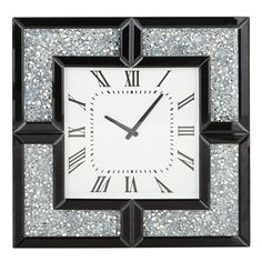 a black and white clock with roman numerals on it's face is shown