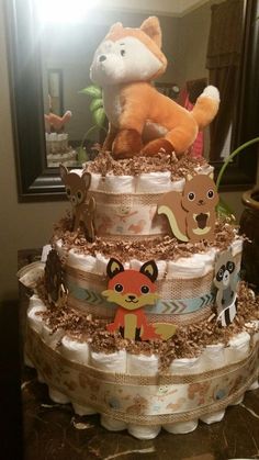 a diaper cake with stuffed animals on top