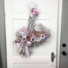 the door is decorated with pink and white flowers, ribbons and polka dot ribbones