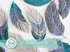 several blue and silver feathers on a white background with the words handmade featheries