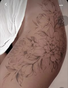 a woman's thigh with flowers on it