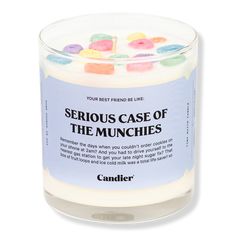 a candle that is filled with candies on the inside and in it's glass container