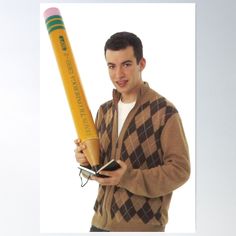 a young man holding a giant pencil in his hand