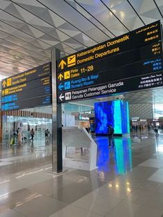 there are many signs at the airport that point in different directions for people to see