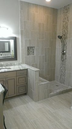 a bathroom with a walk in shower sitting next to a sink and a bathtub