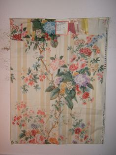 an old wall hanging with flowers on it