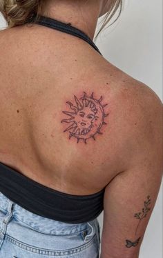 a woman with a sun tattoo on her back