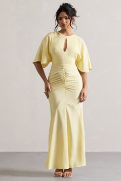 As elegant as its name, introducing our Elidy maxi dress. This enchanting piece has been cut in our premium lightweight woven fabric in light pastel yellow. Elidy features romantic flutter-sleeves and a contemporary chest cut-out that leads down to a ruched bodice. If sophistication was a dress this would be it-especially when it's styled with a tousled bun and our Nadina earrings.Features- Premium lightweight woven- Flutter sleeves- chest cut out- Partial ruching - Invisible zip closure- Maxi lengthSizing & FitModel is 5'6" and wears UK size 8 / US size 4Product InformationDesigned exclusively by Club L LondonUnlined with little stretchPremium lightweight woven in Pastel Yellow (95% Polyamide, 5% Elastane)140cm total lengthSKU: CL132229165 Mustard Dress Outfit Wedding, Elegant Maxi Dress With Sleeves Classy, Dress For Broad Shoulder Women, Wedding Guest Dress Modest, Wedding Guest Dresses Spring, Yellow Fitted Dress With Gathered Sleeves, Curvy Dress Wedding Guest, Bridgerton Inspired Dresses, Feminine Yellow Fitted Maxi Dress