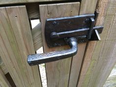 an old metal door handle on a wooden fence