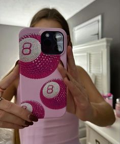 a woman taking a selfie with her cell phone in front of her face and holding it up to the camera