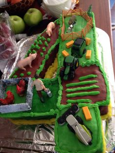 two cakes decorated with farm animals and tractors